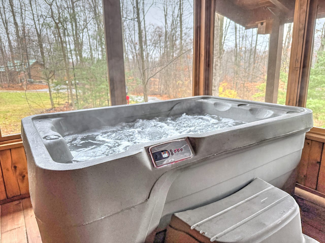Private outdoor hot tub with a wooded view at Sycamore Lane Cabin, Ferngully Creek in Millersburg, Ohio